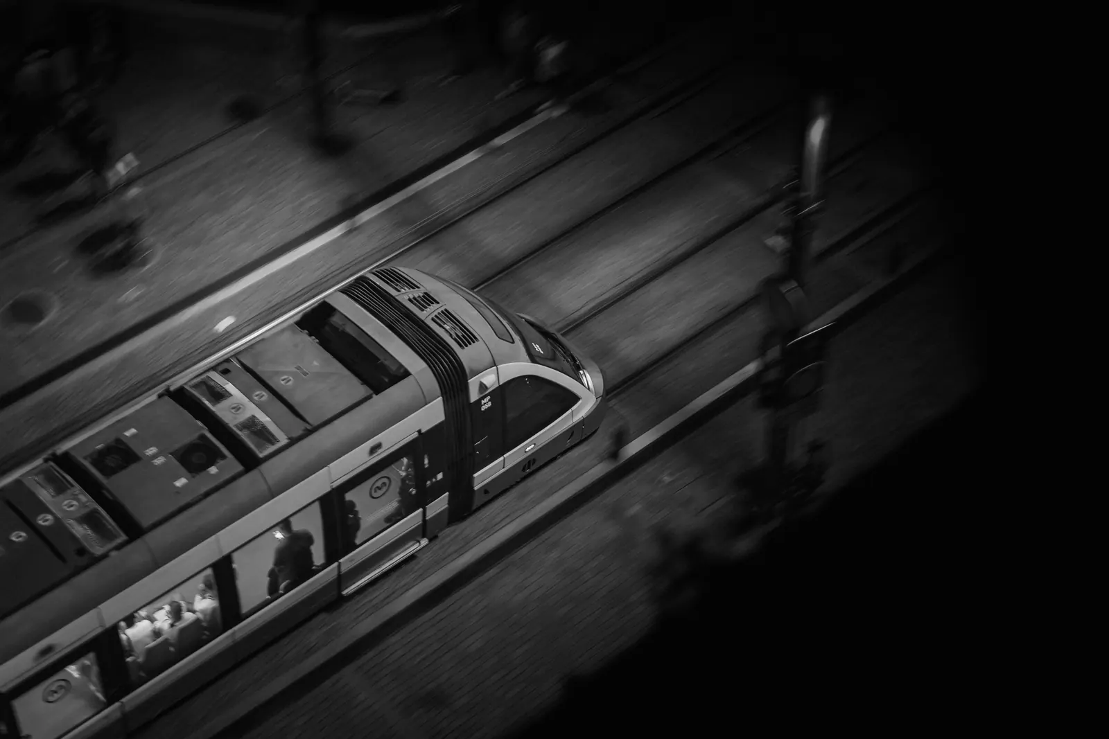 A train moving along its tracks at night, seen from above. Photo by Jordan Ryskamp.